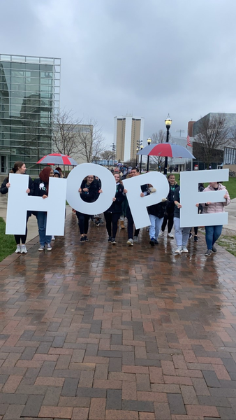 Attendees of OOTDW walking with the letter signs, spelling out HOPE