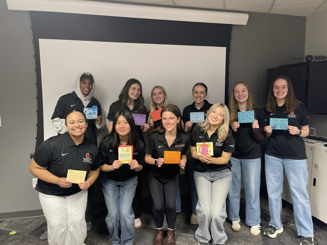 Several student PROs holding positive affirmation cards they each made.